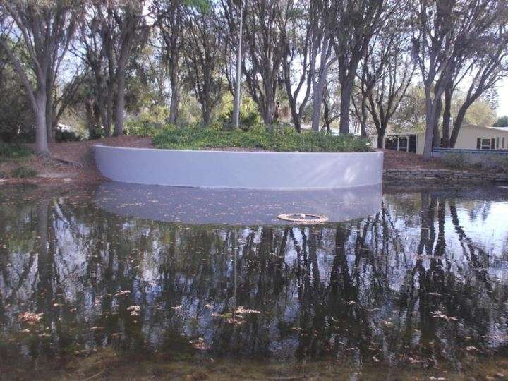After Repainting of a pond retaining wall in Edgewater, FL