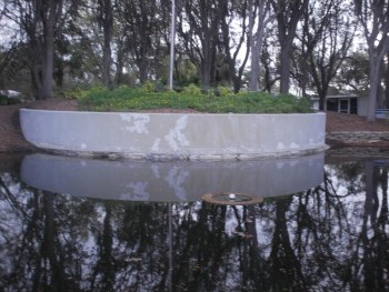 Before Repainting of a pond retaining wall in Edgewater, FL